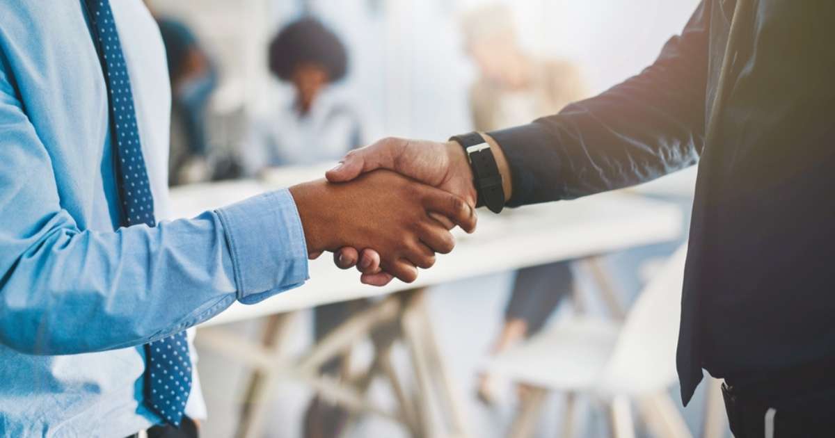 Two people shaking hands after negotiating an early termination penalty