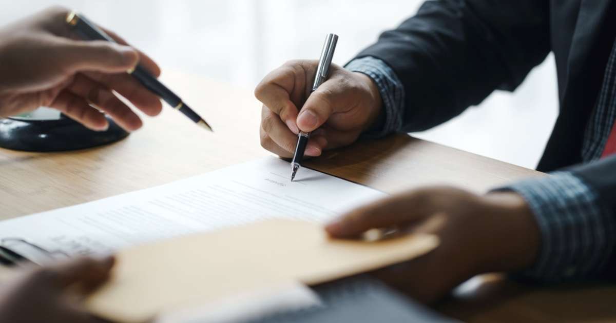Two people writing a notice to a landlord