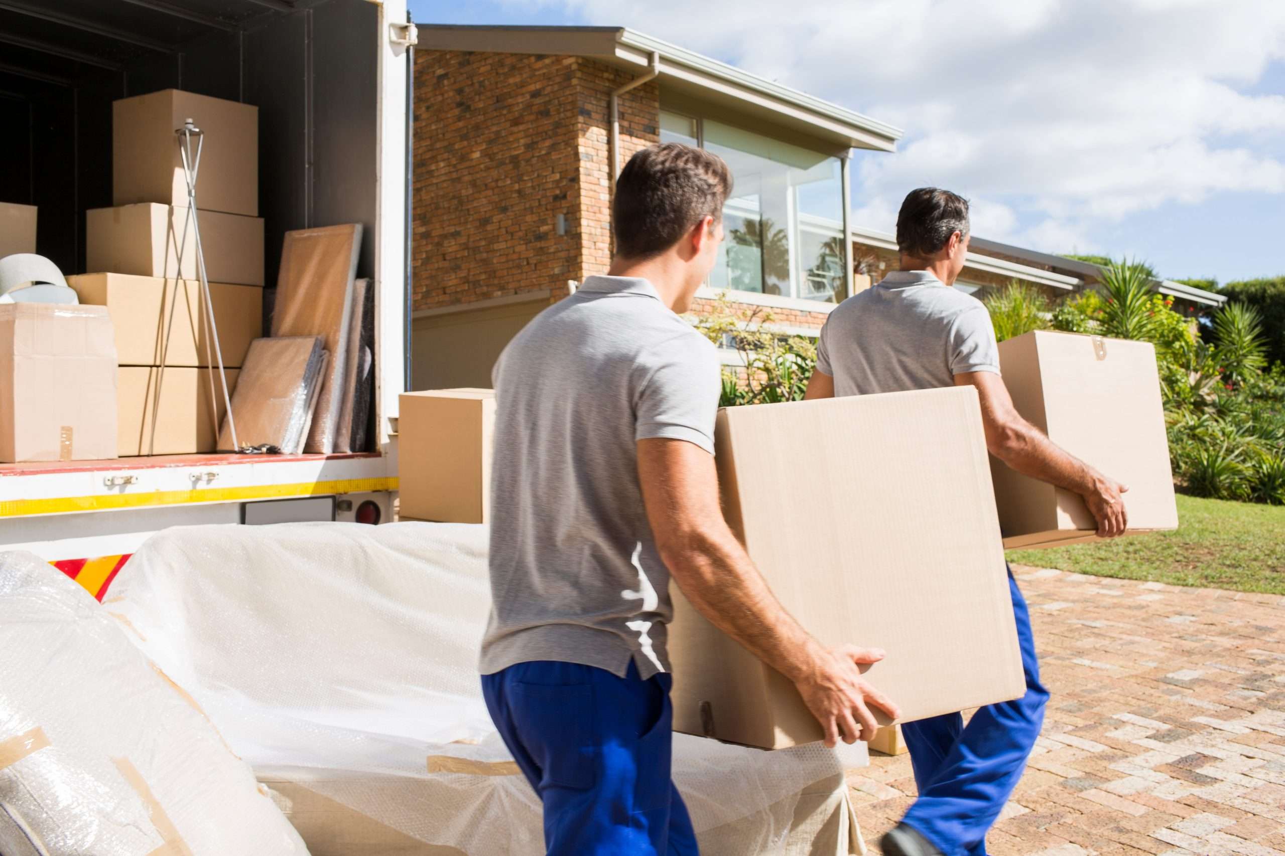  Seville movers loading boxes into the back of a moving truck 